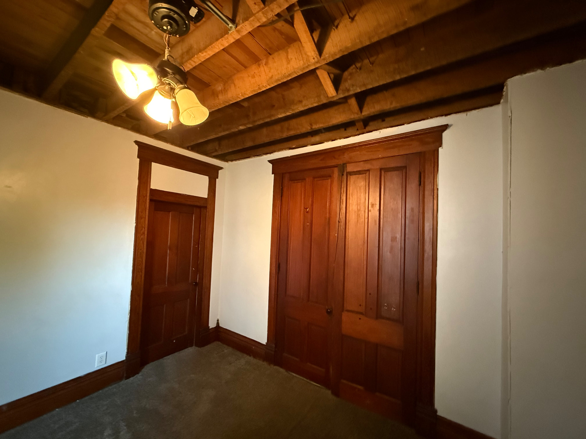Ceiling with affected drywall removed and clean exposed framing after mold remediation