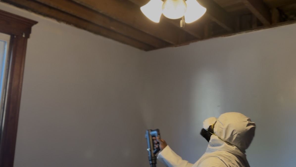 Technician fogging an affected room with antimicrobial treatment after mold removal