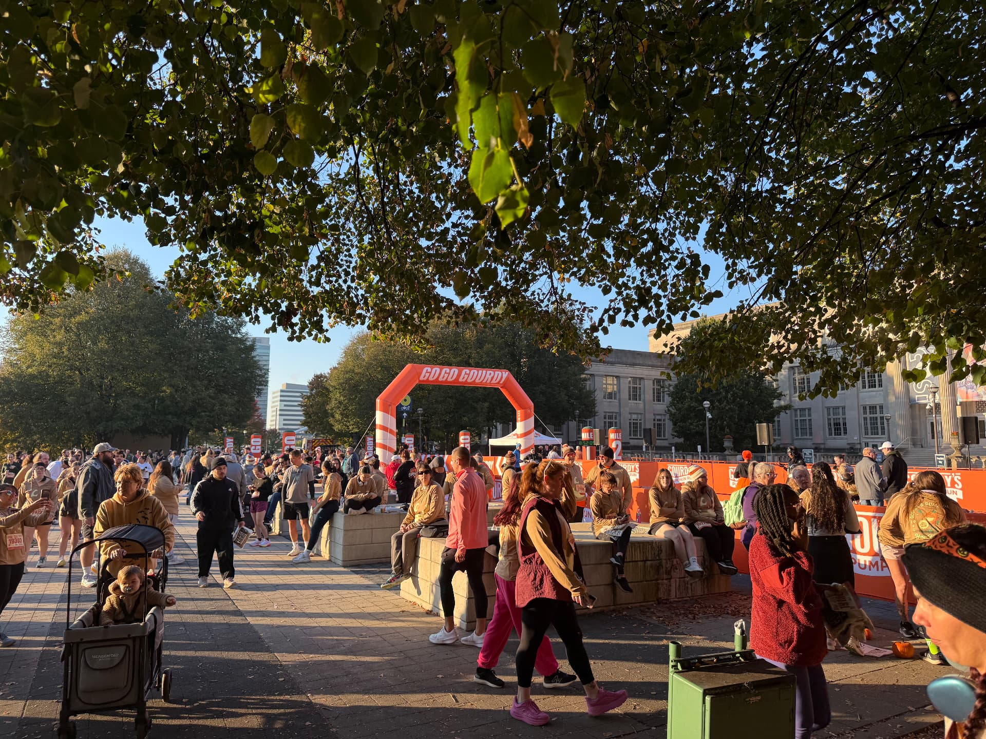 Crowd of runners and walkers gathered under the inflatable finish arch at Gordy's Pumpkin Run 5K 2026
